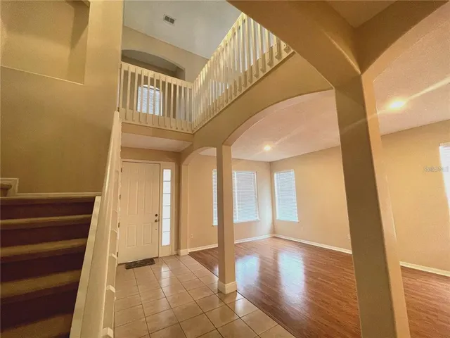 a view of an entryway with wooden floor