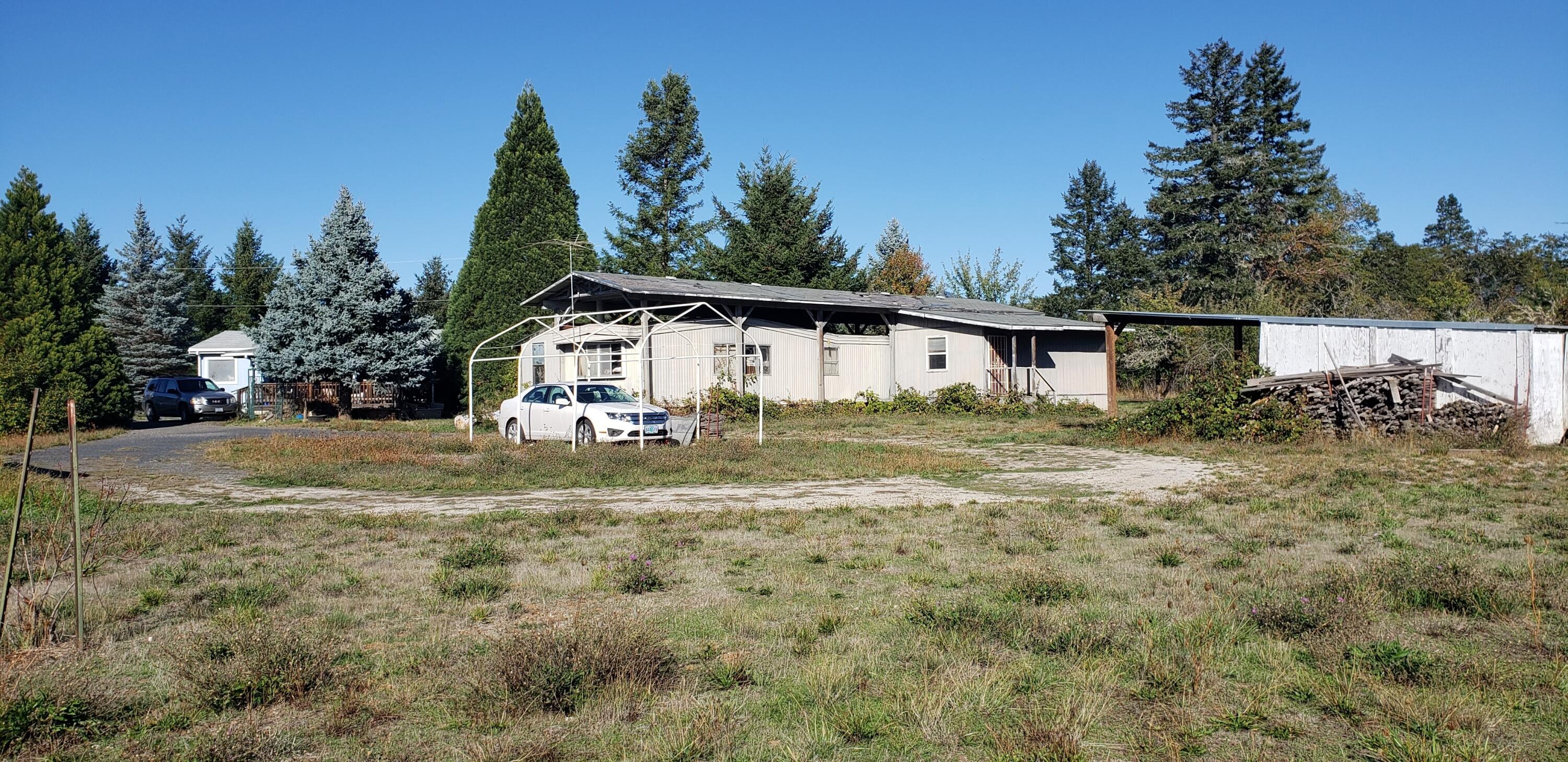 5565 Holland Loop Road Cave Junction, OR 97523 - Photo 17 of 19 Distant view of back of mh that is approved accessory bldg.