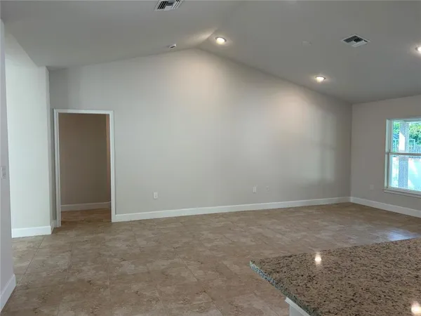 an empty room with windows and closet