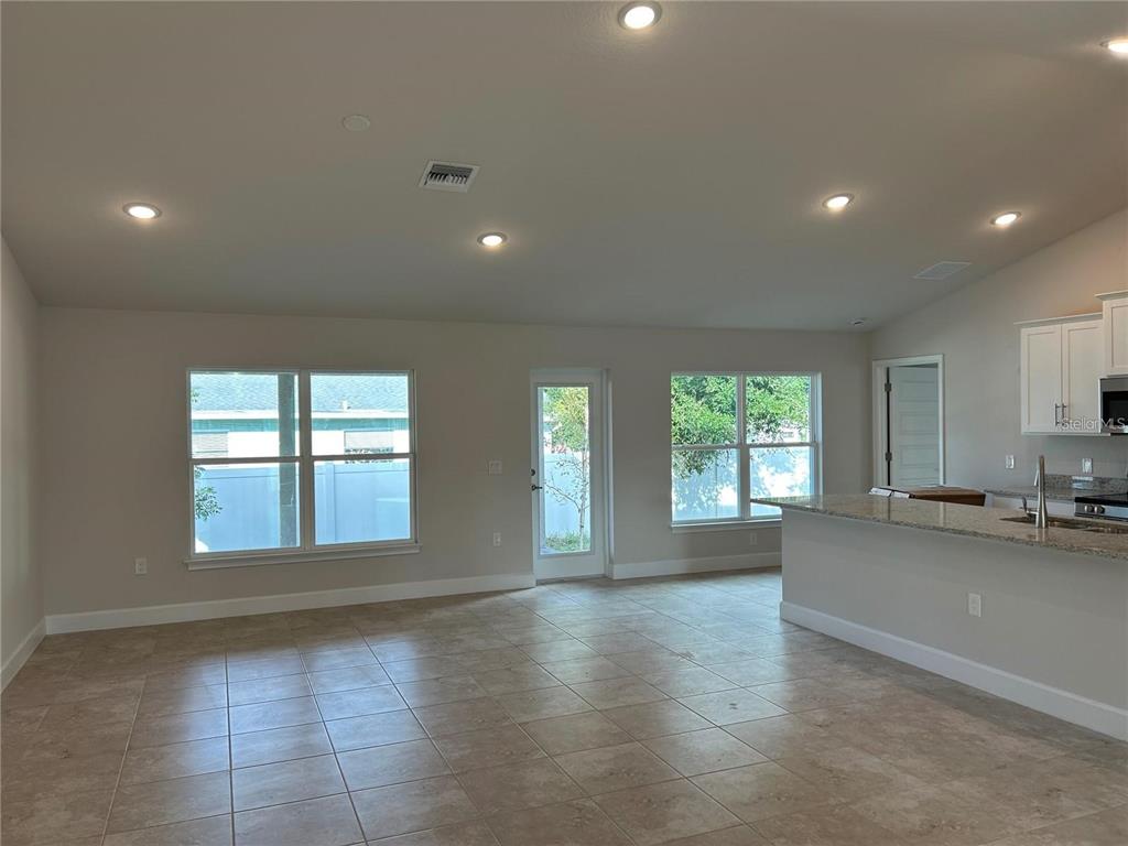 2679 Englewood Road Venice, FL 34293 - Photo 5 of 14 a view of an empty room with a window and wooden floor