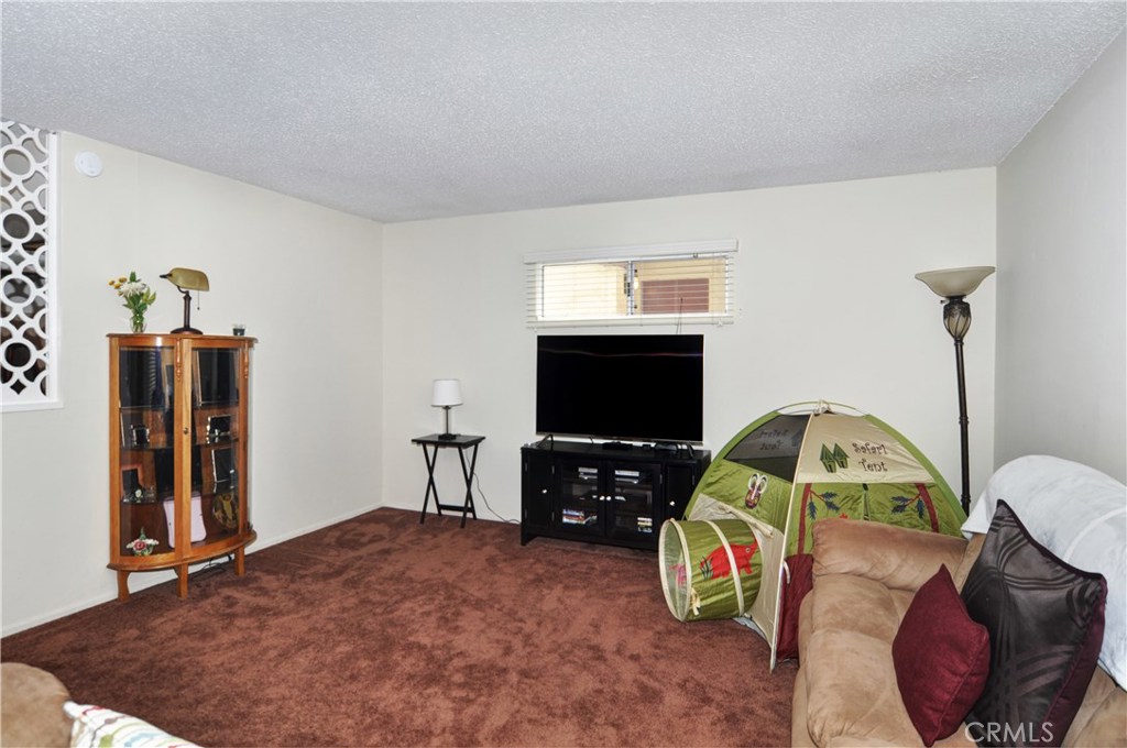 217 10th Street, Unit 4 Seal Beach, CA 90740 - Photo 12 of 45 a living room with furniture and a flat screen tv