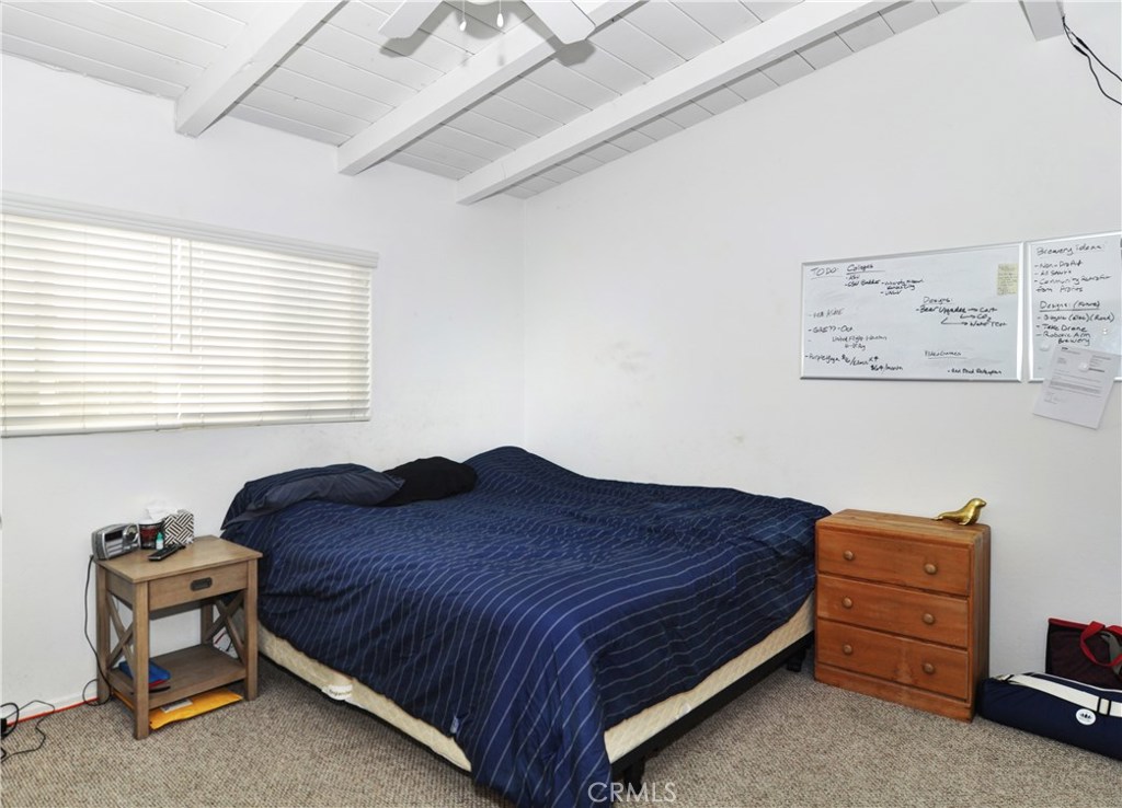 217 10th Street, Unit 4 Seal Beach, CA 90740 - Photo 13 of 45 a bedroom with a bed and a window