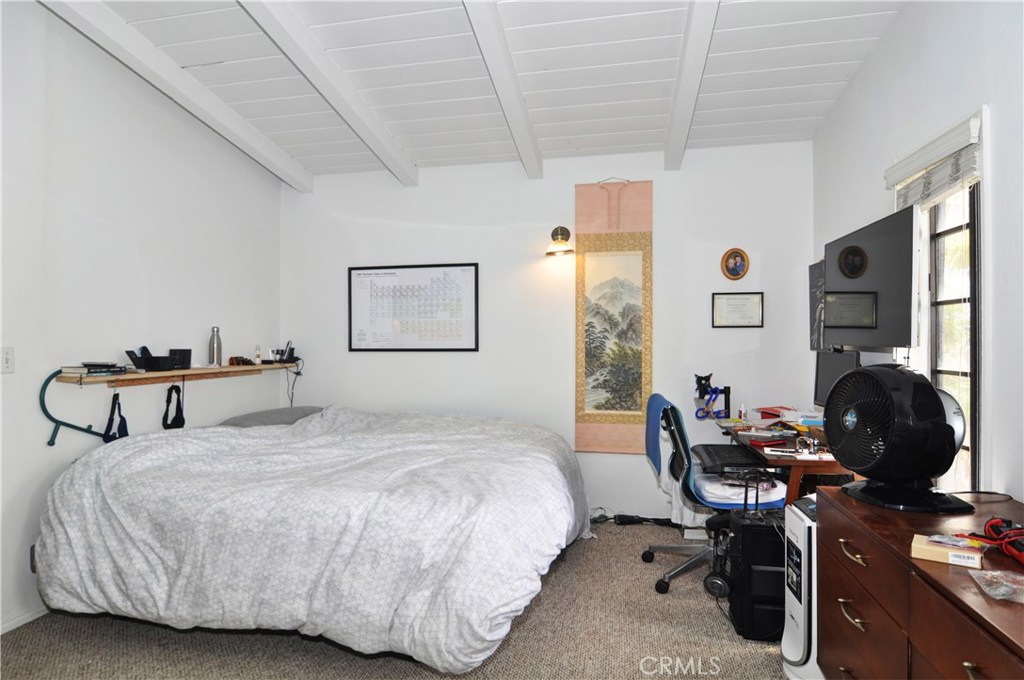 217 10th Street, Unit 4 Seal Beach, CA 90740 - Photo 16 of 45 a bedroom with a bed and a potted plant