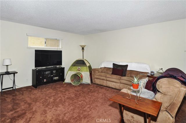 a bedroom with furniture and a flat screen tv