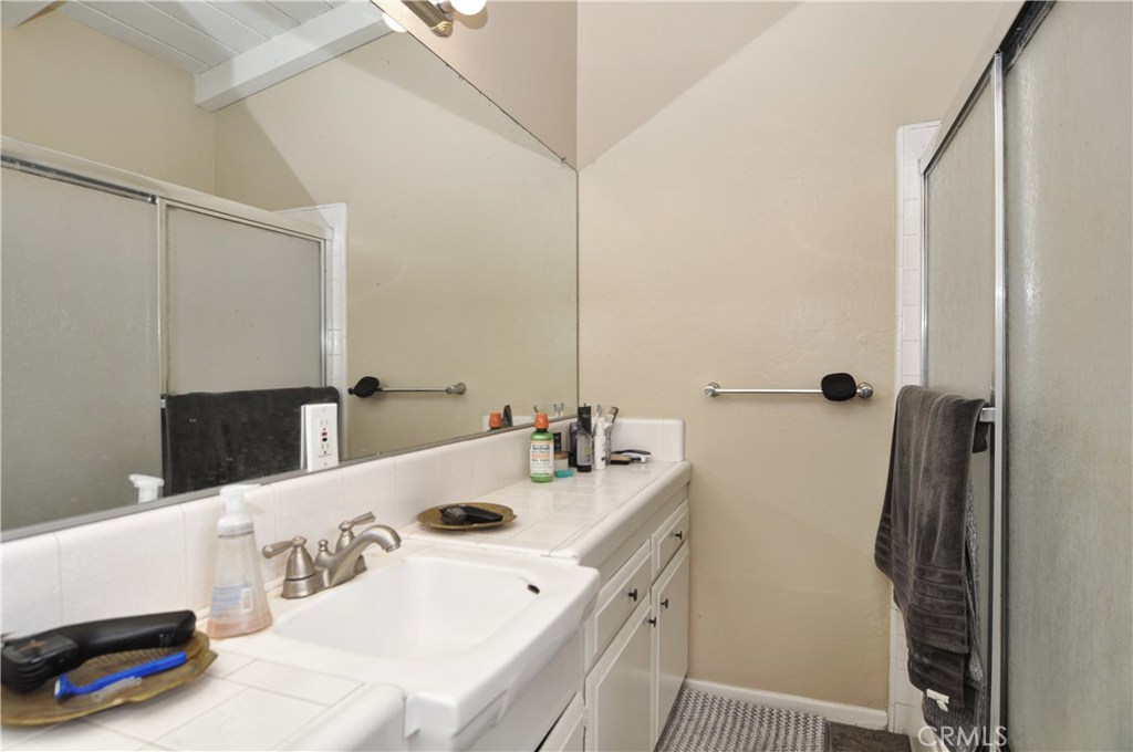 217 10th Street, Unit 4 Seal Beach, CA 90740 - Photo 21 of 45 a bathroom with a sink and a mirror