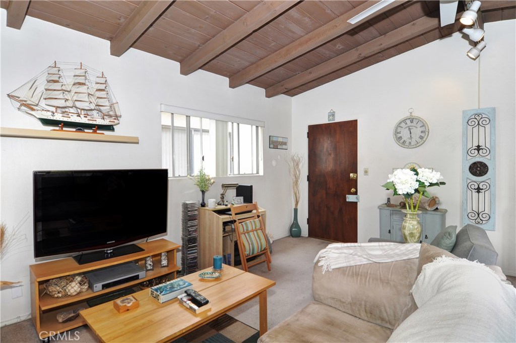 217 10th Street, Unit 4 Seal Beach, CA 90740 - Photo 26 of 45 a bedroom with furniture and a flat screen tv