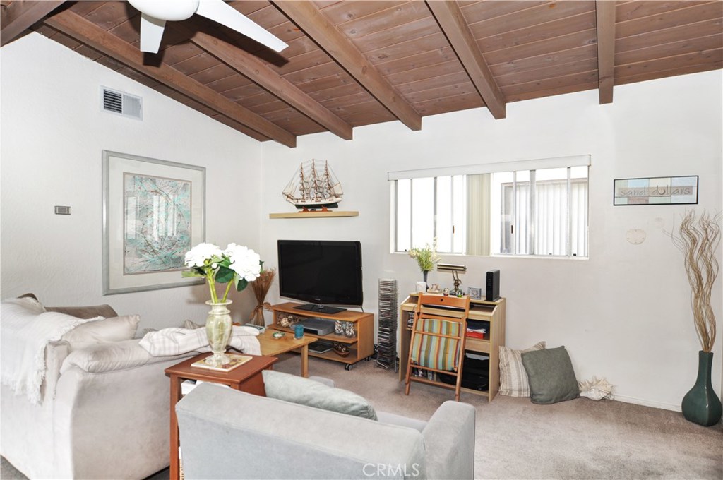 217 10th Street, Unit 4 Seal Beach, CA 90740 - Photo 27 of 45 a work room with furniture and a flat screen tv