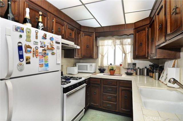 a kitchen with stainless steel appliances granite countertop a sink and cabinets