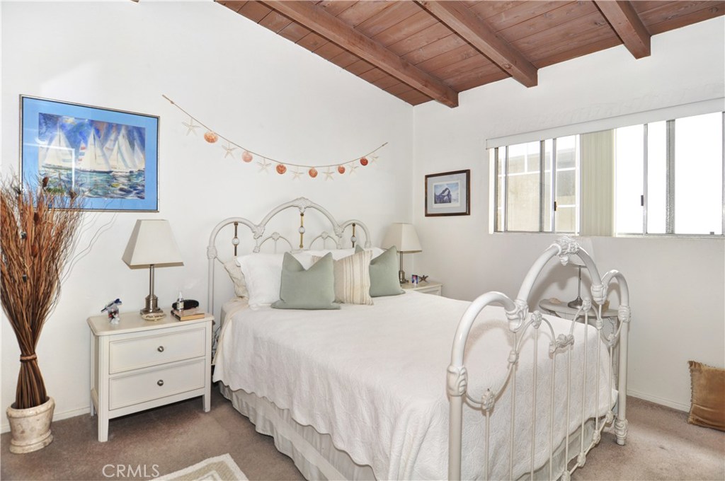 217 10th Street, Unit 4 Seal Beach, CA 90740 - Photo 33 of 45 a bed room with a bed and a chair