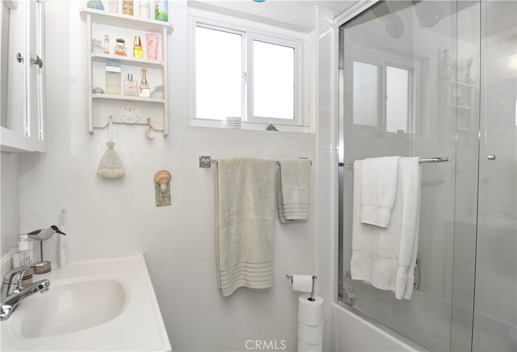 217 10th Street, Unit 4 Seal Beach, CA 90740 - Photo 35 of 45 a bathroom with a sink a toilet and shower
