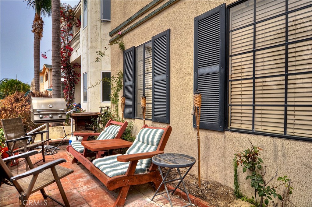 217 10th Street, Unit 4 Seal Beach, CA 90740 - Photo 45 of 45 a couple of chairs sitting in front of a house