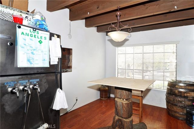 a view of a room with furniture and wooden floor