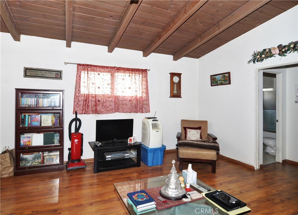 217 10th Street, Unit 4 Seal Beach, CA 90740 - Photo 9 of 45 a living room with furniture a flat screen tv and a fireplace