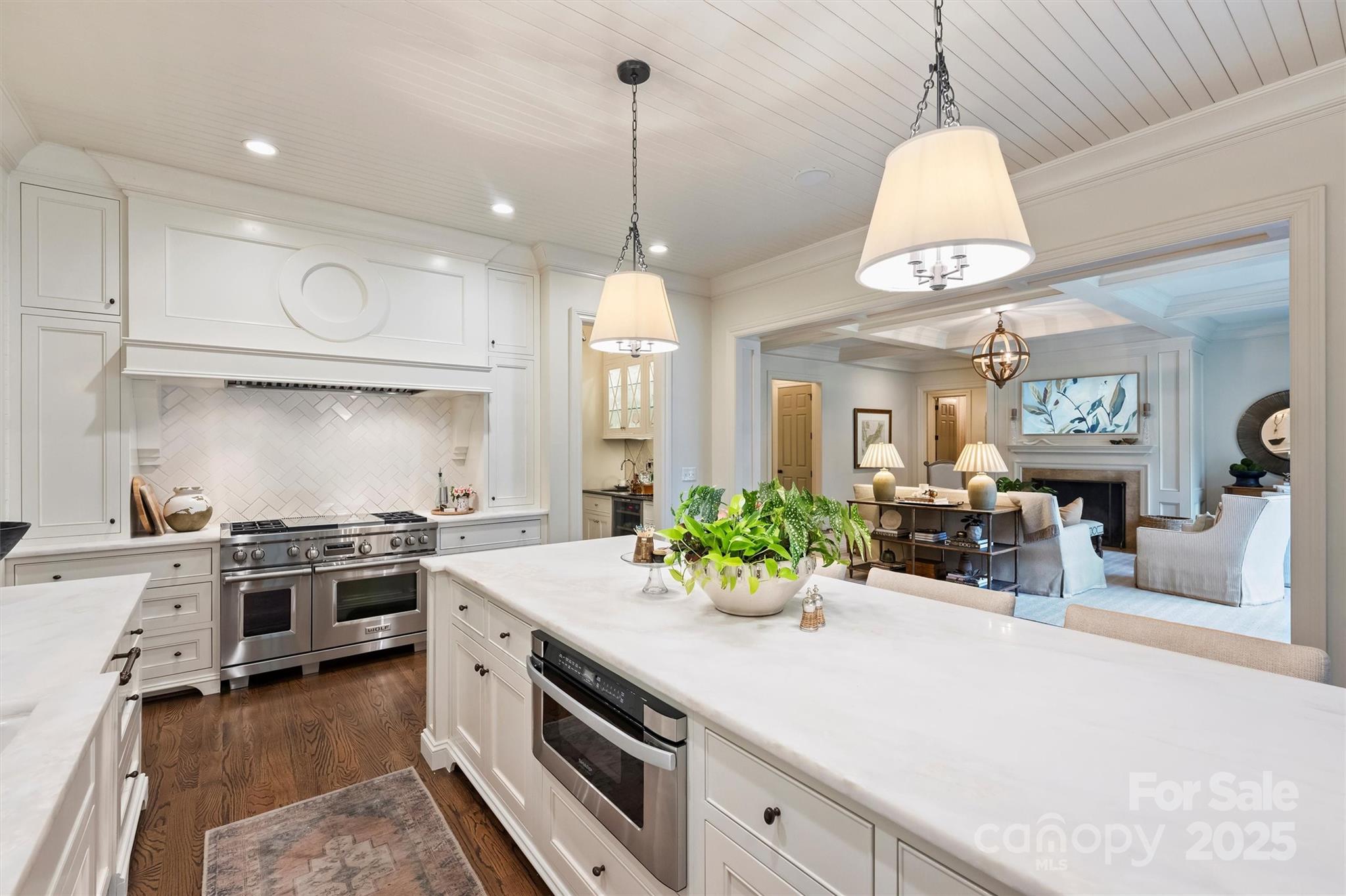 3950 Abingdon Road Charlotte, NC 28211 - Photo 11 of 43 a kitchen with stainless steel appliances a stove a sink a chimney and a wooden floor