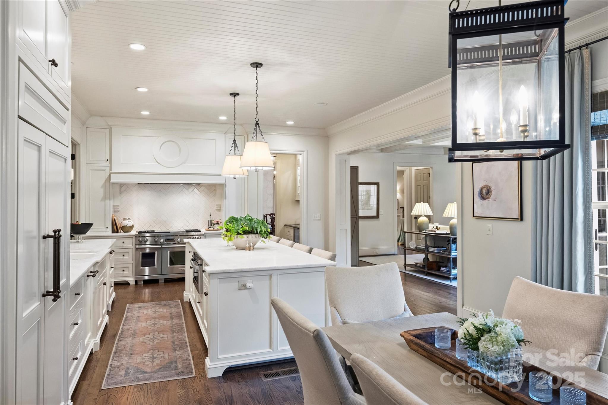3950 Abingdon Road Charlotte, NC 28211 - Photo 14 of 43 a kitchen with stainless steel appliances kitchen island granite countertop a stove a sink a refrigerator and a dining table with wooden floor