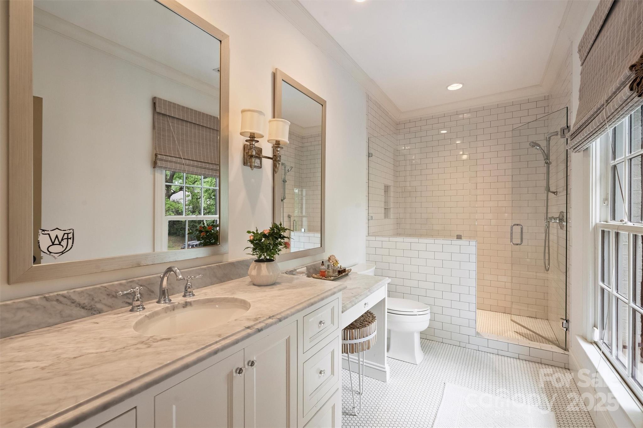 3950 Abingdon Road Charlotte, NC 28211 - Photo 31 of 43 a bathroom with a granite countertop sink a toilet a mirror and shower