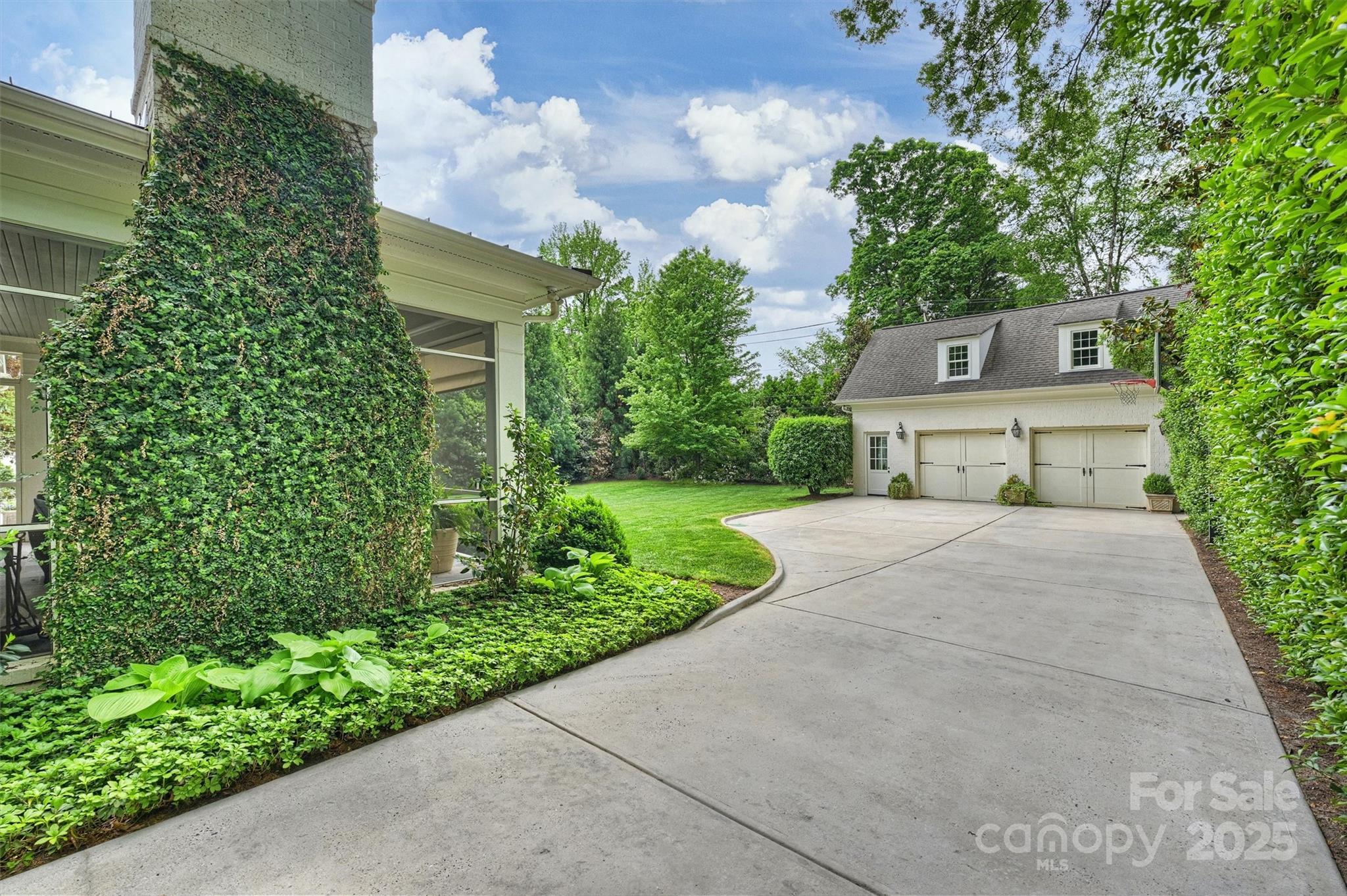 3950 Abingdon Road Charlotte, NC 28211 - Photo 41 of 43 a front view of a house with a yard and fountain in middle