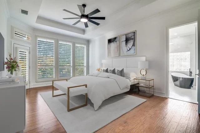 a bedroom with a large bed and a chandelier