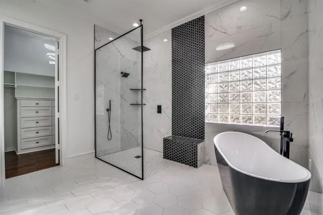 a bathroom with a tub a toilet and a window