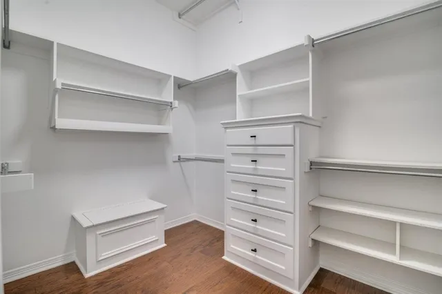 a view of walk in closet with empty racks