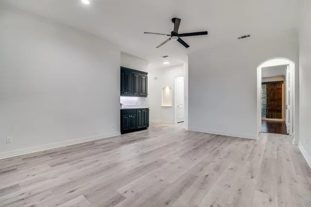 a view of empty room with wooden floor and fireplace