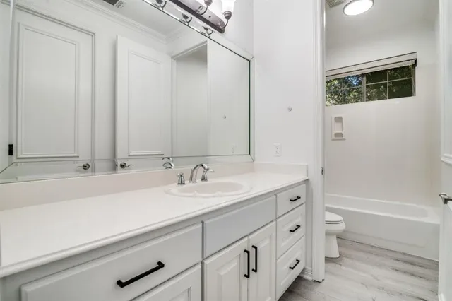 a bathroom with a sink a toilet and a bathtub