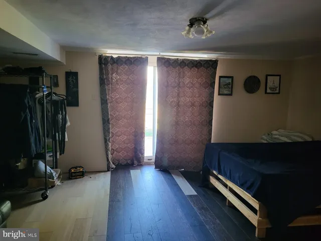 a backyard of a house with table and chairs plants and large trees