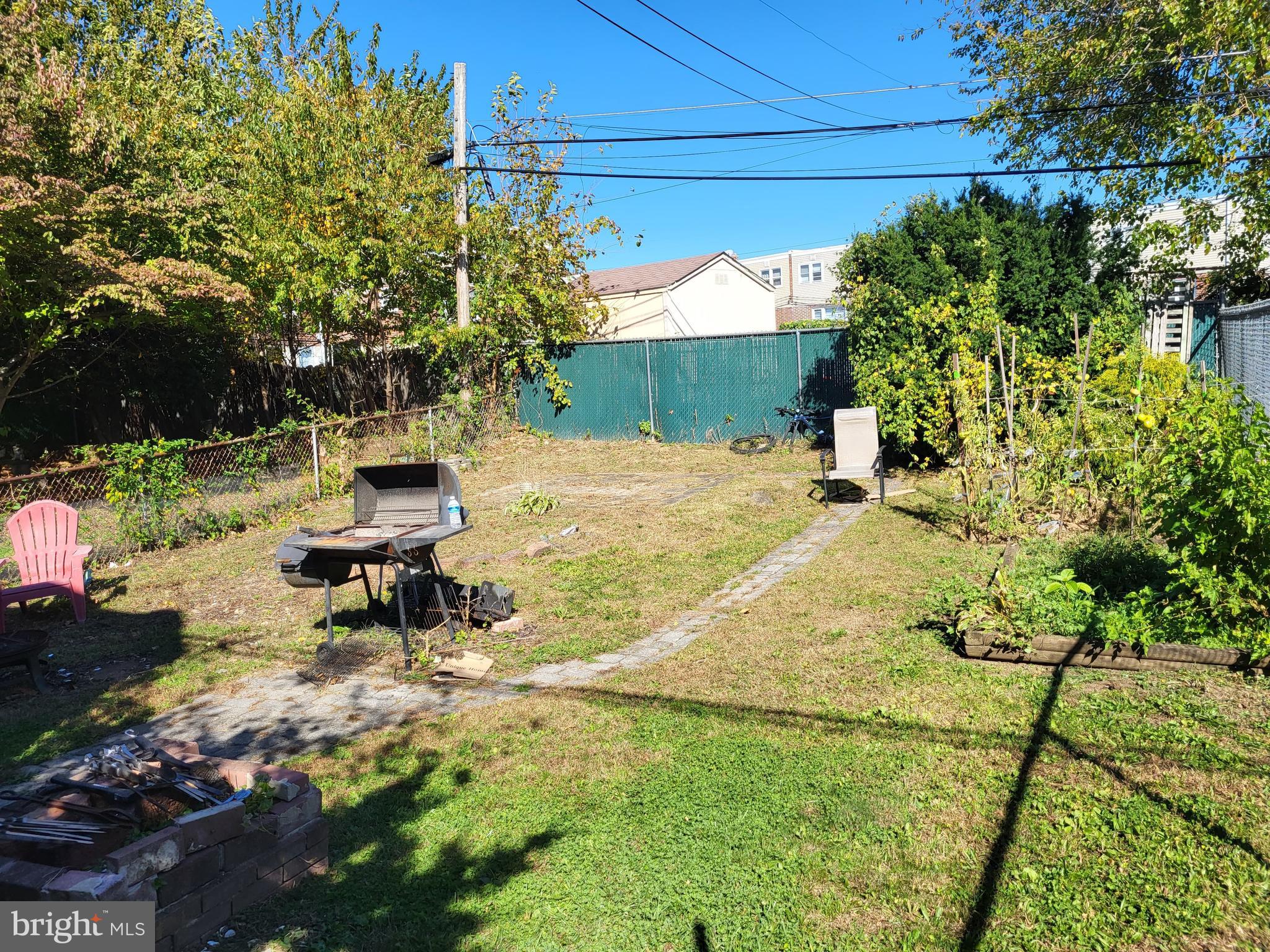 1907 Nester Street Philadelphia, PA 19115 - Photo 15 of 16 a backyard of a house with table and chairs plants and large trees