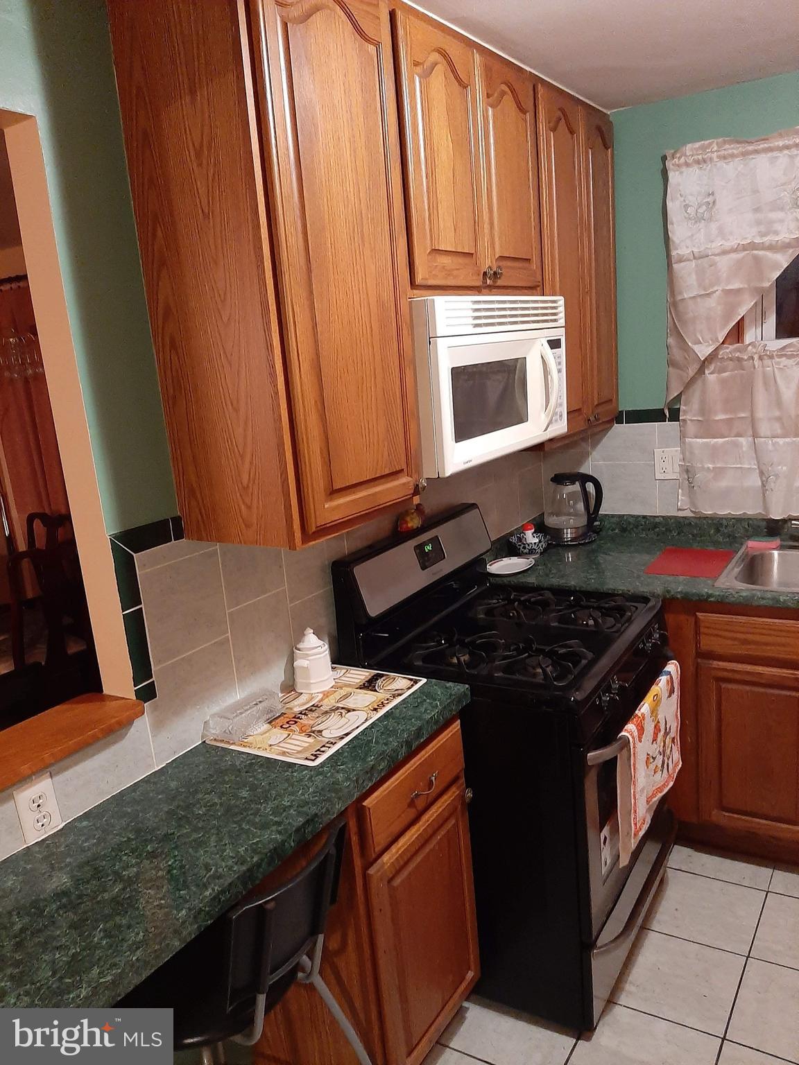 1907 Nester Street Philadelphia, PA 19115 - Photo 8 of 16 a kitchen with stainless steel appliances granite countertop a stove a sink and a microwave