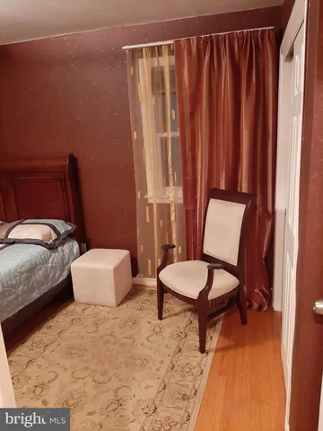 a bedroom with a bed and wall painting