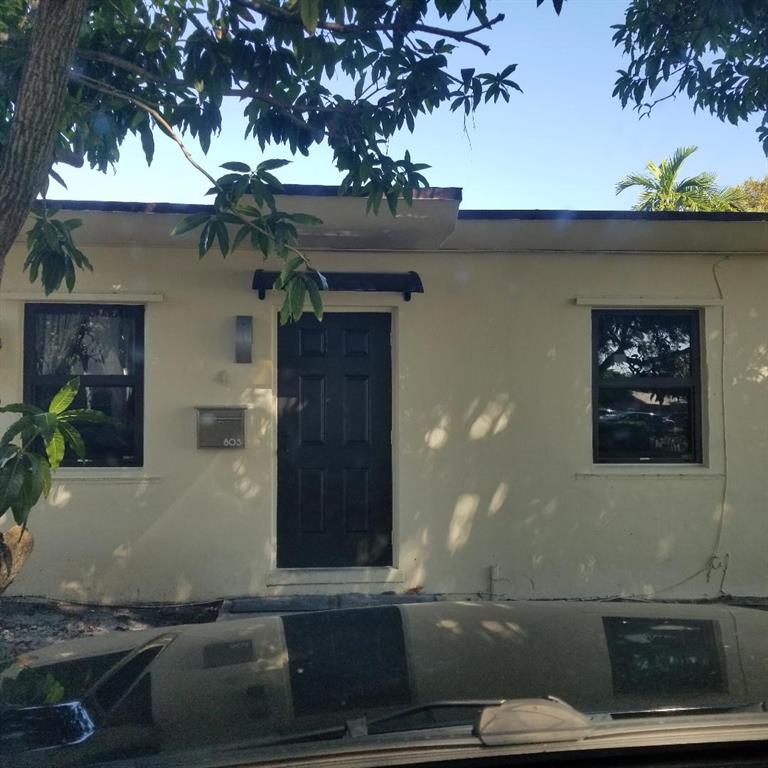 803 Northeast 8th Street Hallandale Beach, FL 33009 - Photo 13 of 38 a front view of a house with trees
