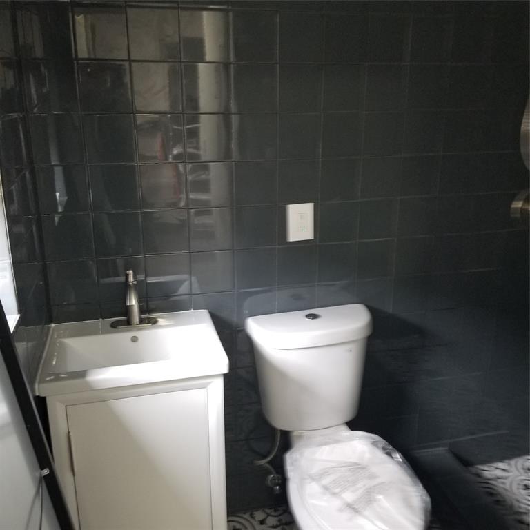 803 Northeast 8th Street Hallandale Beach, FL 33009 - Photo 15 of 38 a white toilet sitting next to a bathroom sink