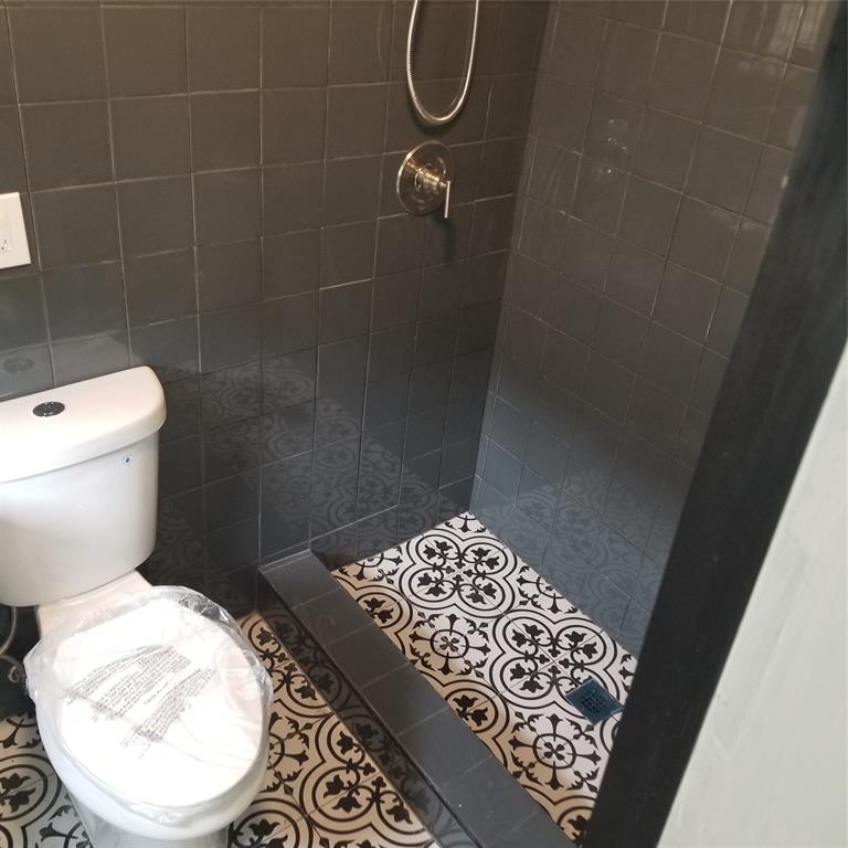 803 Northeast 8th Street Hallandale Beach, FL 33009 - Photo 16 of 38 a bathroom with a toilet and a shower