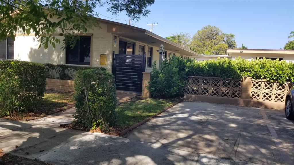 803 Northeast 8th Street Hallandale Beach, FL 33009 - Photo 2 of 38 a backyard of a house with lots of green space
