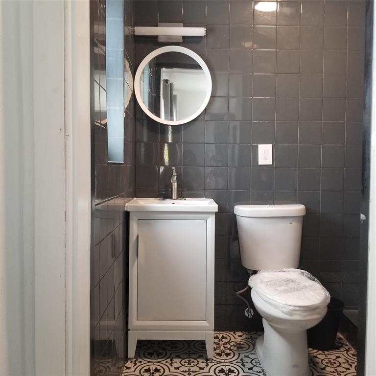 803 Northeast 8th Street Hallandale Beach, FL 33009 - Photo 24 of 38 a bathroom with a toilet and a sink