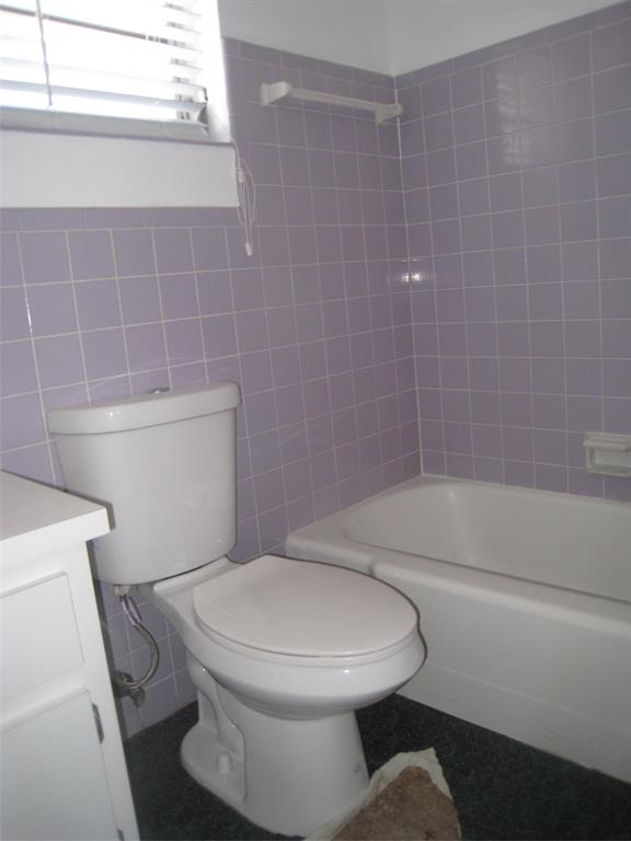 803 Northeast 8th Street Hallandale Beach, FL 33009 - Photo 27 of 38 a white toilet sitting next to a bath tub