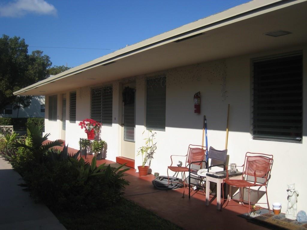 803 Northeast 8th Street Hallandale Beach, FL 33009 - Photo 30 of 38 a view of a patio with table and chairs potted plants with floor to ceiling window and potted plants