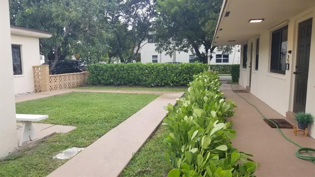 803 Northeast 8th Street Hallandale Beach, FL 33009 - Photo 3 of 38 a front view of a house with a yard