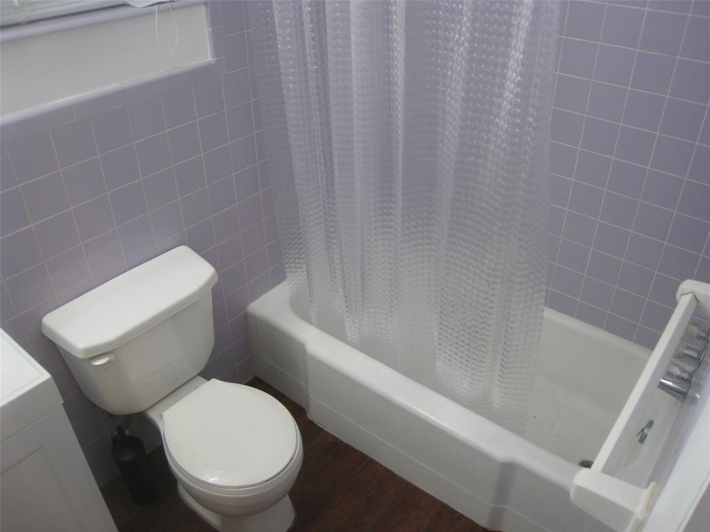 803 Northeast 8th Street Hallandale Beach, FL 33009 - Photo 31 of 38 a white toilet sitting next to a bath tub