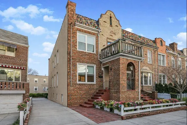 a front view of a residential apartment building with a yard