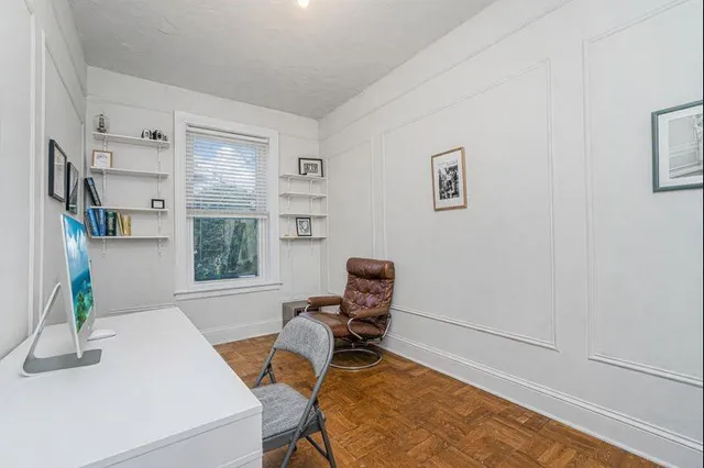 a room with furniture a rug and a window