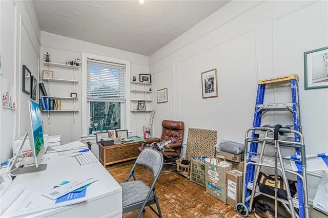 a bedroom with a large bed and a chandelier