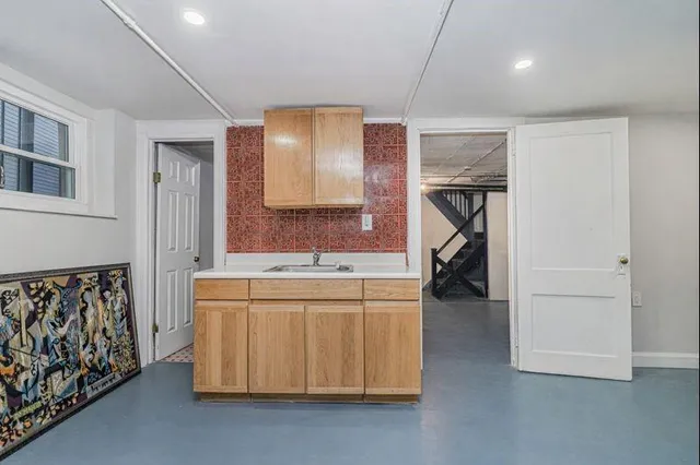 a bedroom with a bed and a view of kitchen