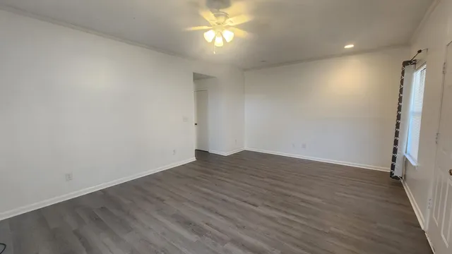 wooden floor in an empty room with a window