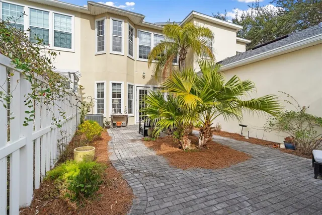 a view of a multi story house with a garden