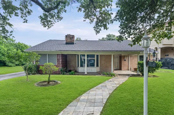 a front view of a house with a yard and porch