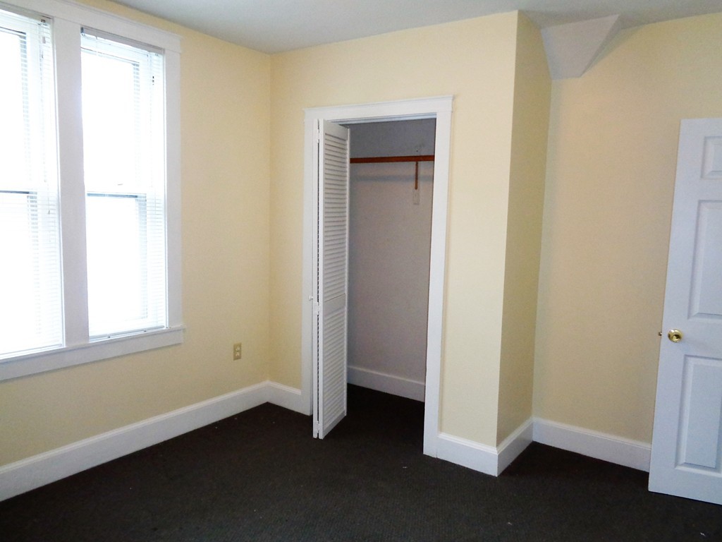 76 Stony Hill Road Wilbraham, MA 01095 - Photo 11 of 22 a view of an empty room with wooden floor and a window