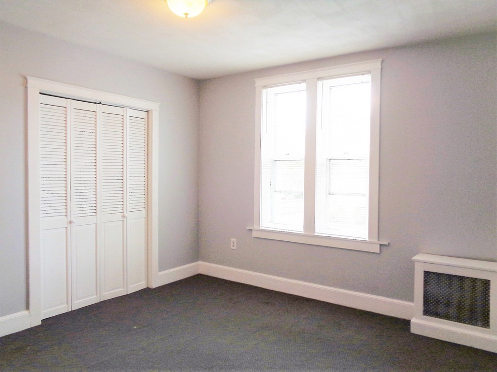76 Stony Hill Road Wilbraham, MA 01095 - Photo 13 of 22 an empty room with a fireplace and a window