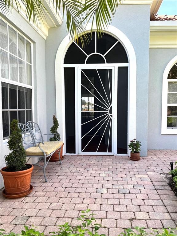 5477 Freeport Lane Naples, FL 34119 - Photo 2 of 36 a outdoor space with lots of potted plants