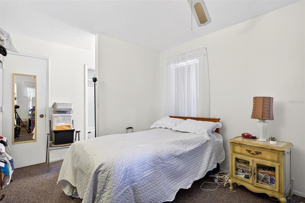 464 Coronado Road Venice, FL 34293 - Photo 14 of 28 a bedroom with a bed and a tv in it